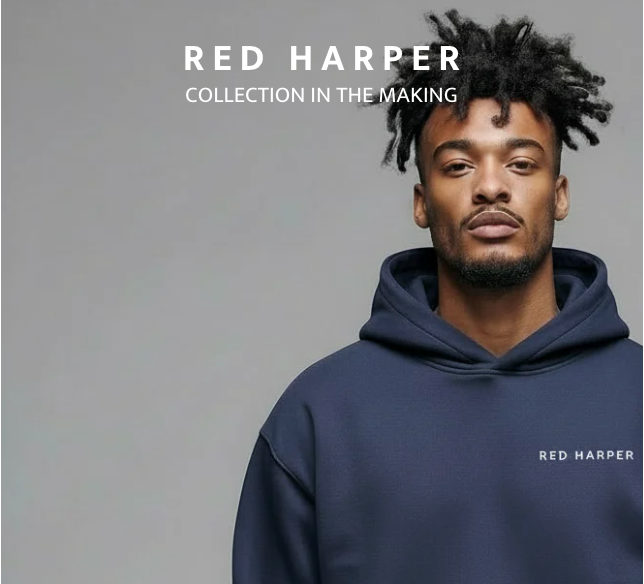 Studio portrait of a person wearing a navy blue hoodie with ‘Red Harper’ text on the chest, standing against a plain light background. White overlay text reads ‘RED HARPER – Collection in the Making.’